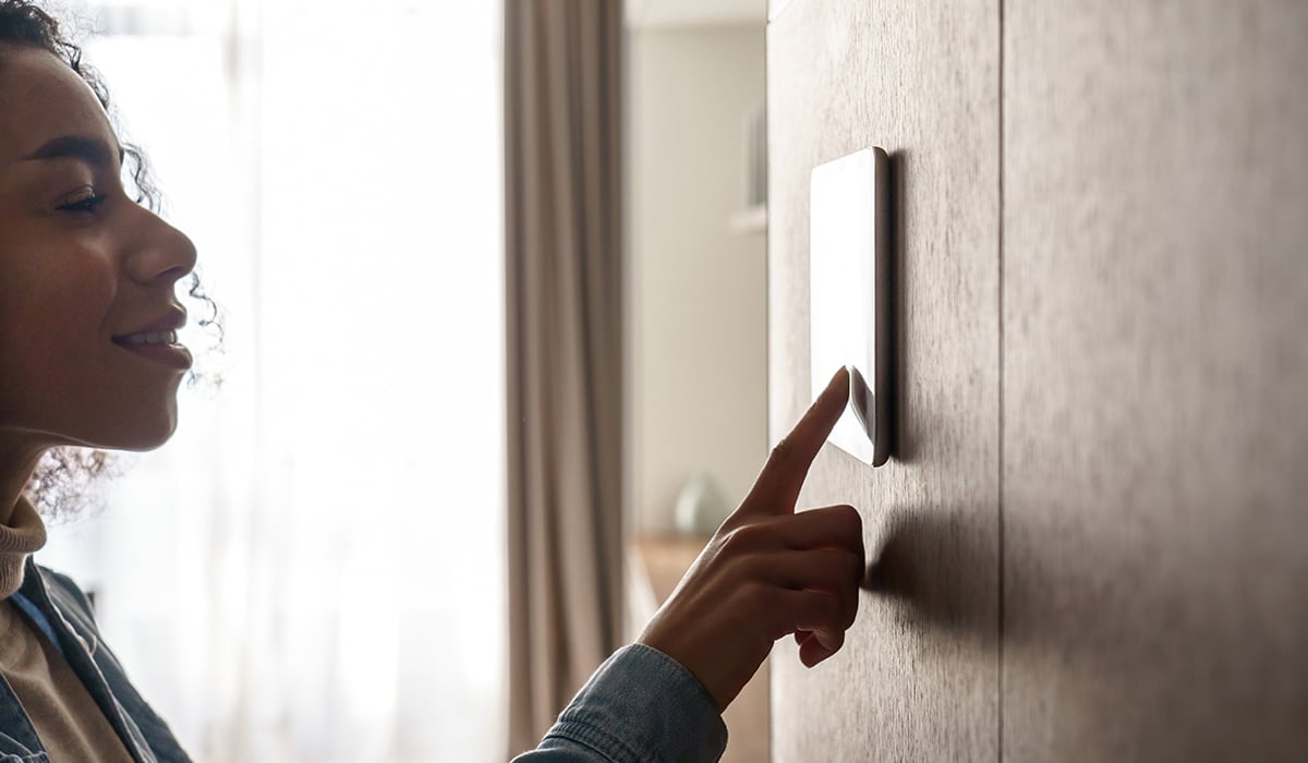 African american woman using smart security screen in house African american woman using smart security screen in house