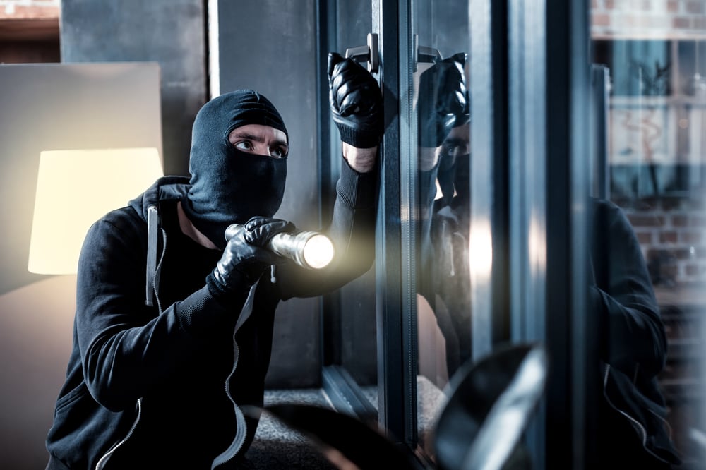 Burglar looking into residential house Burglar looking into residential house