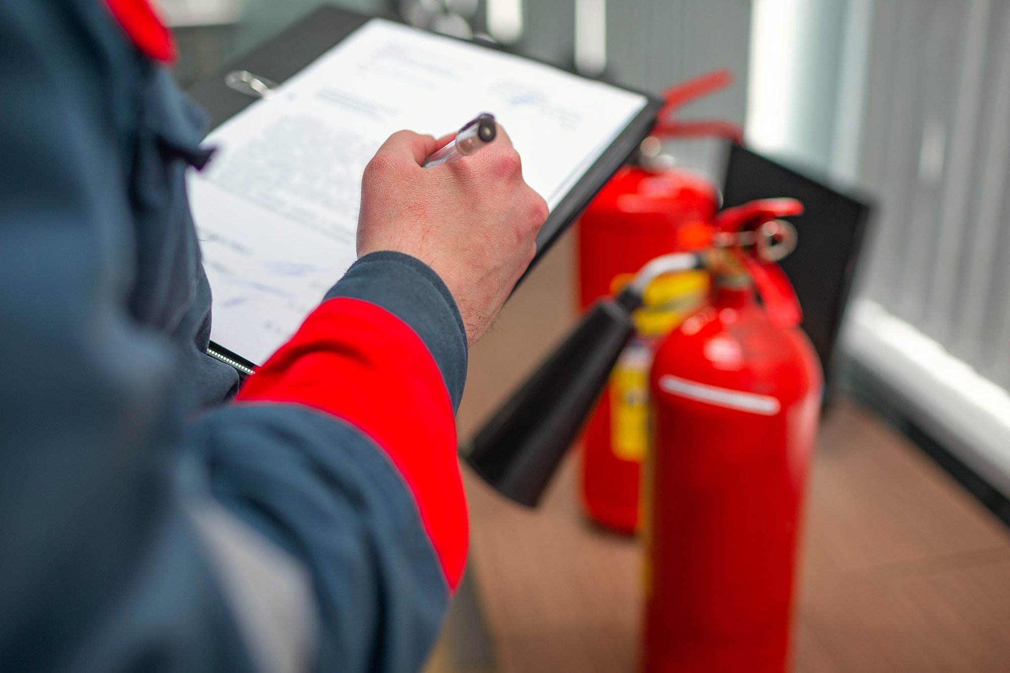 Fire inspector taking notes on clipboard Fire inspector taking notes on clipboard