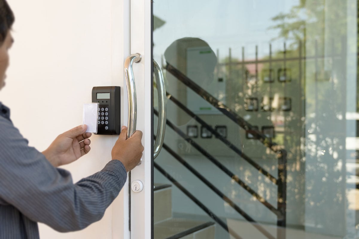 Man scanning card to enter commercial building Man scanning card to enter commercial building