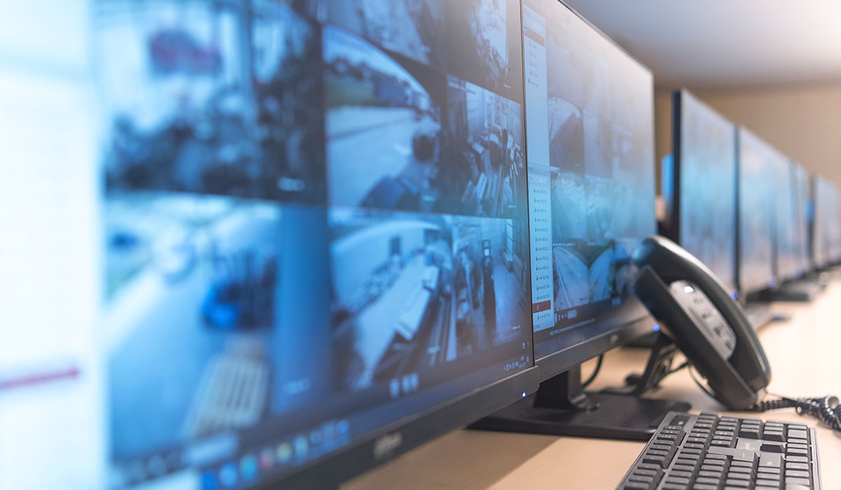 multiple-computer-screens-showing-video-surveillance-footage multiple-computer-screens-showing-video-surveillance-footage