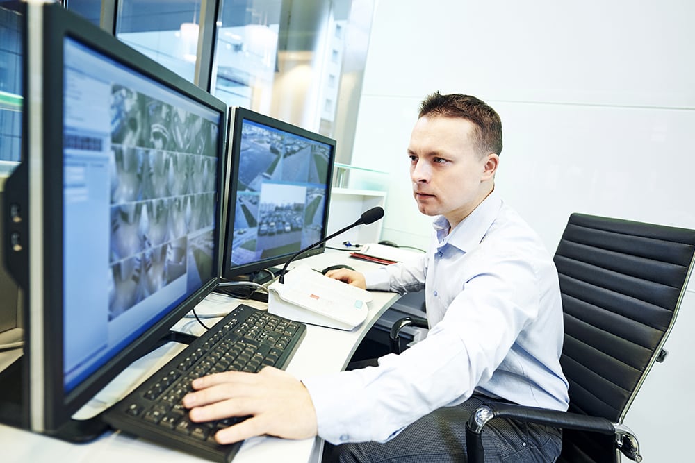 Security monitor looking intensely at monitors Security monitor looking intensely at monitors