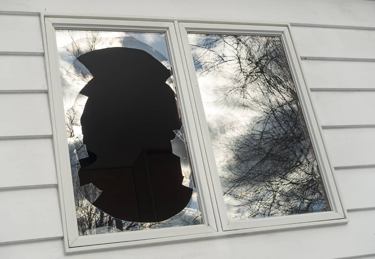 Window on side of house with big break in the window Window on side of house with big break in the window