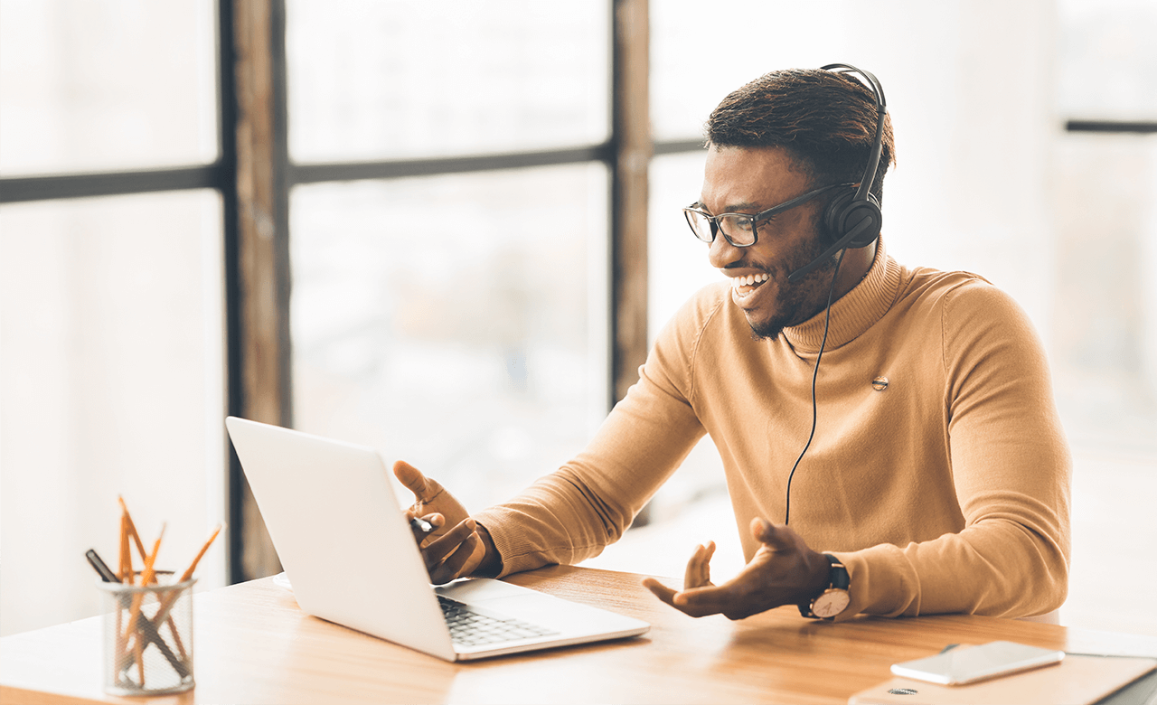 black man using laptop on a conference call black man using laptop on a conference call